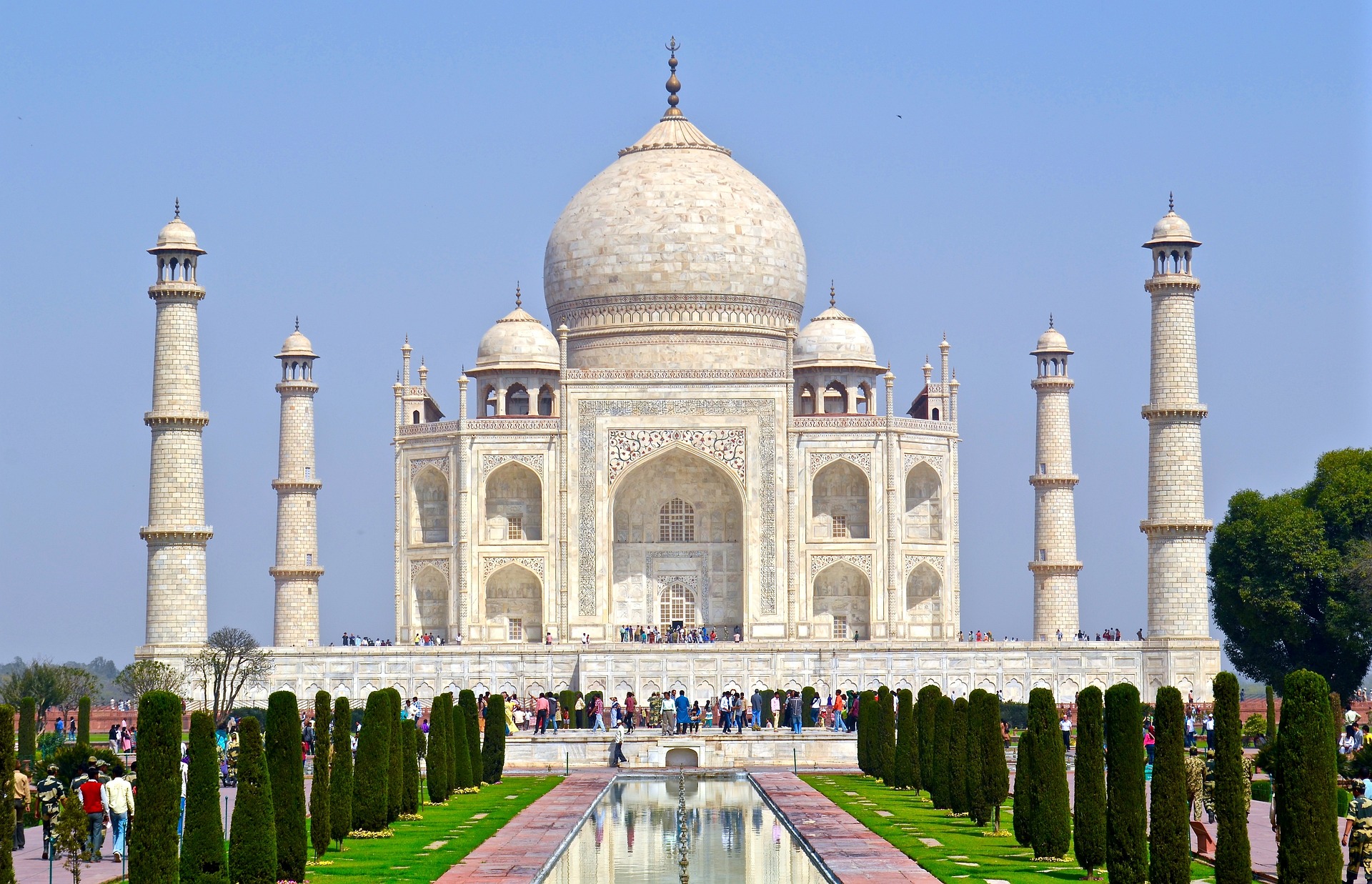 Beautiful white marble structure of Taj Mahal with clear blue sky in the background