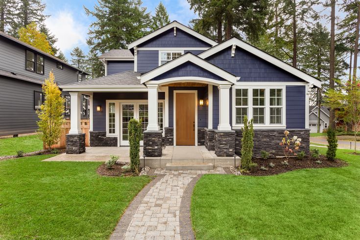 Craftsman Home with Columns and a Wood Front Door